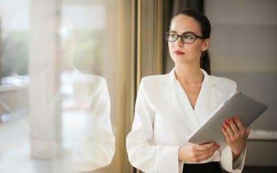 photo-of-woman-in-white-top-and-glasses-holding-a-tablet